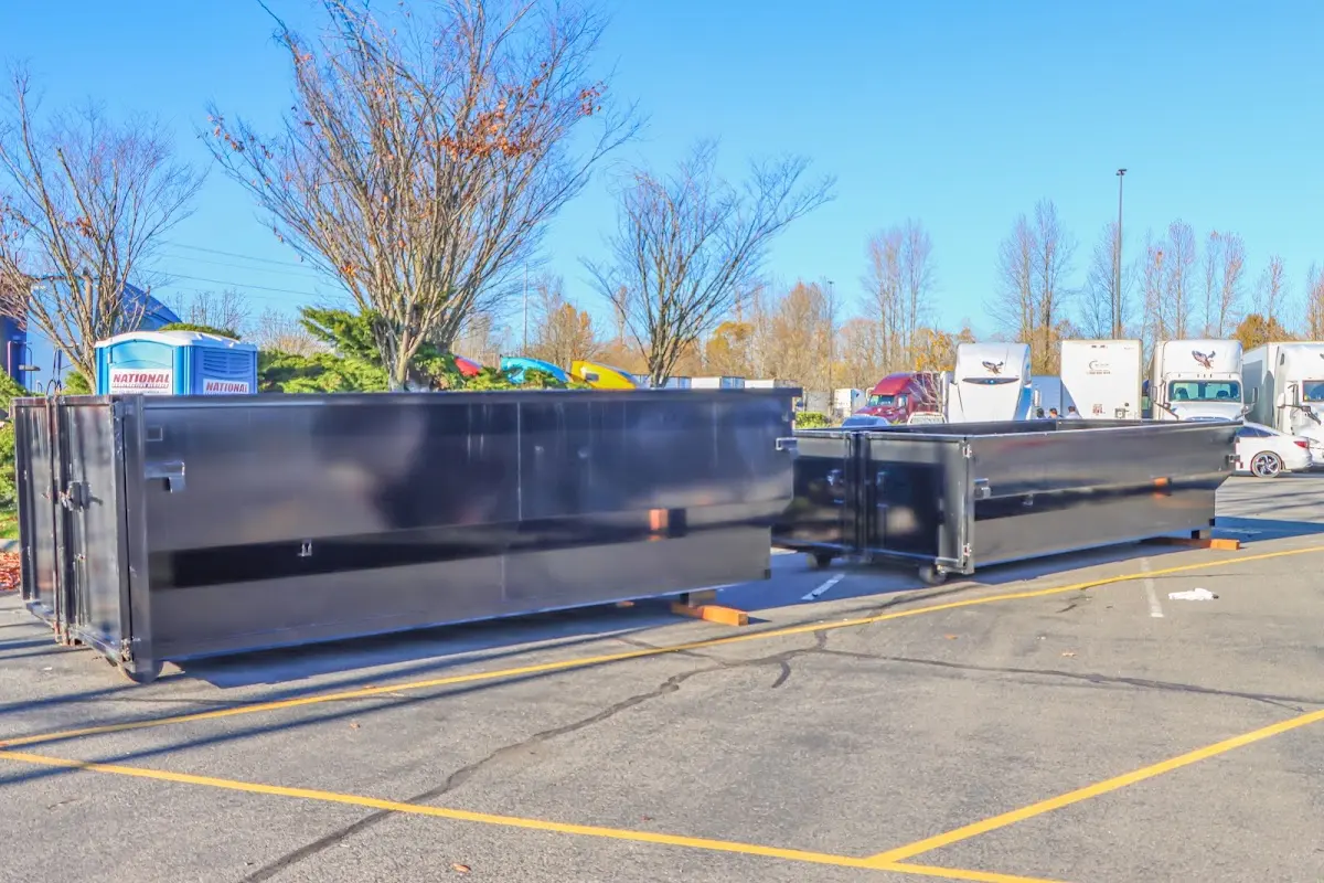 Professional dumpster rental service with roll-off container on residential driveway in Burke Centre